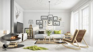 A bright, modern living room with a suspended fireplace, a pallet sofa, a gallery wall, and a rocking chair.
